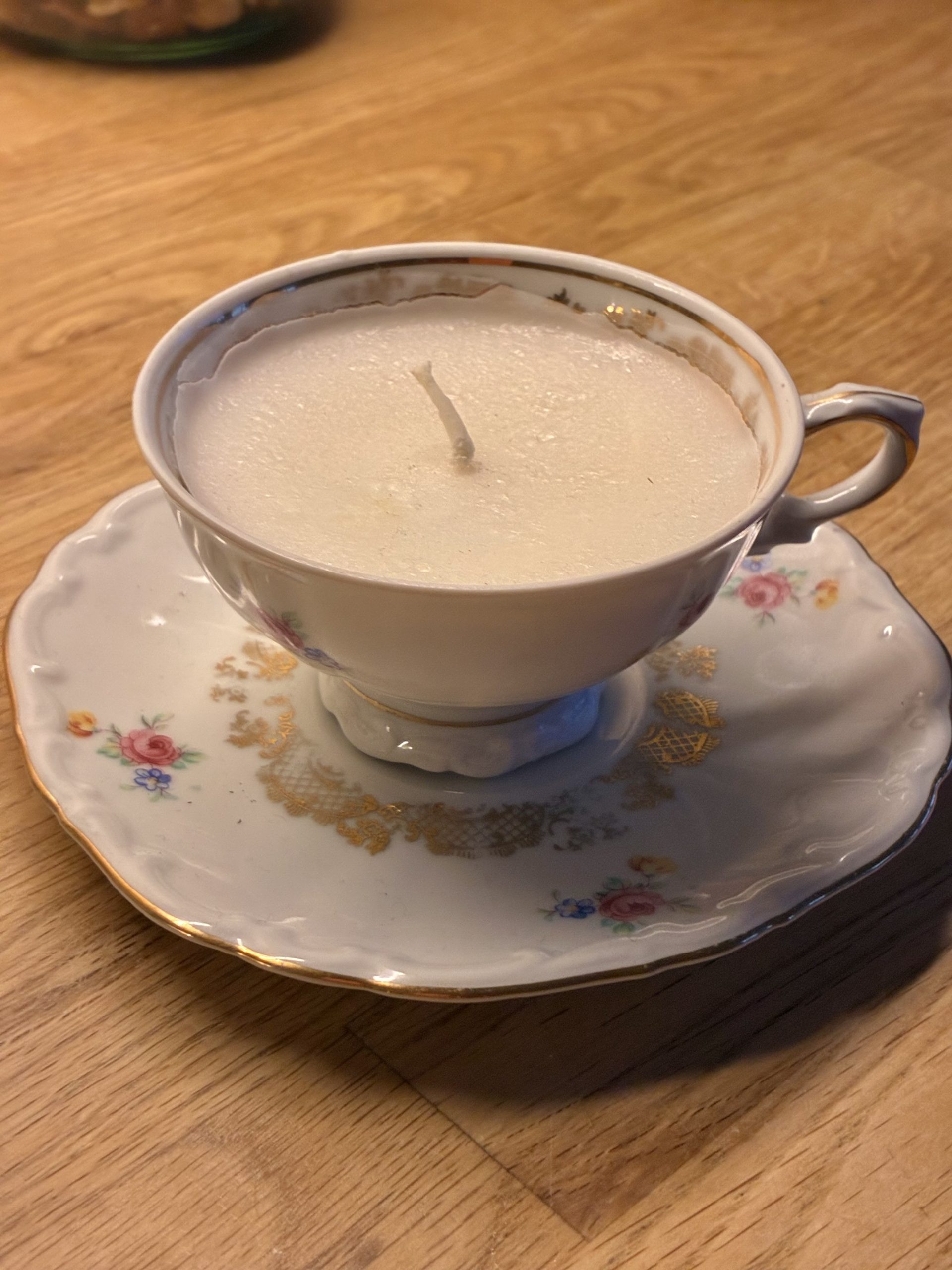 en kopp som gjorts om till ett ljus med veke och stearin